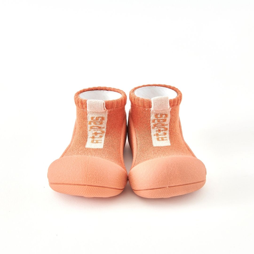 Meias-calçado laranja com sola de borracha e texto BEBÉ.
