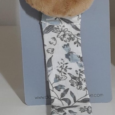 Porta-chupetas para bebé com cabeça de ursinho castanho e fita com padrão floral azul e cinzento