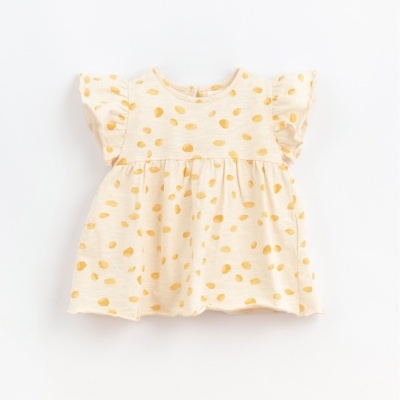 Blusa de bebé creme com bolinhas amarelas em fundo claro