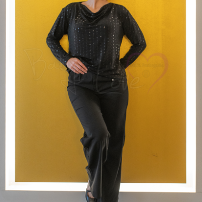 Conjunto feminino preto com blusa de decote drapeado e calças lisas, fundo amarelo