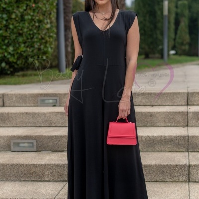 Vestido negro comprido com acessórios vermelhos em cenário exterior