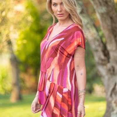 Mulher loira com blusa colorida ao ar livre