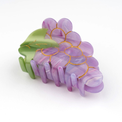 Presilha de cabelo roxa com detalhes dourados e folha verde