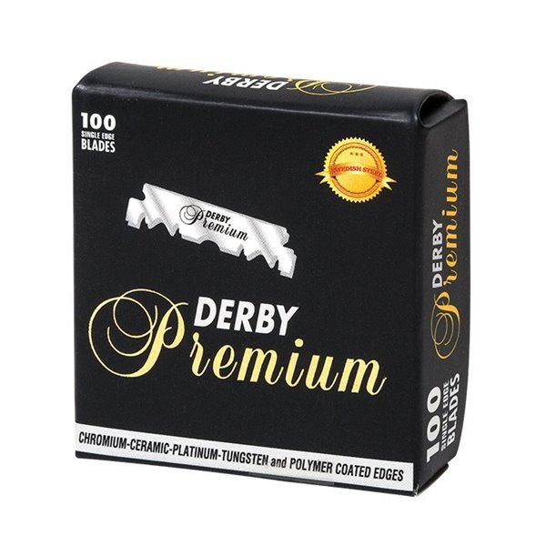 Embalagem preta com texto dourado e branco de lâminas de barbear Derby Premium.