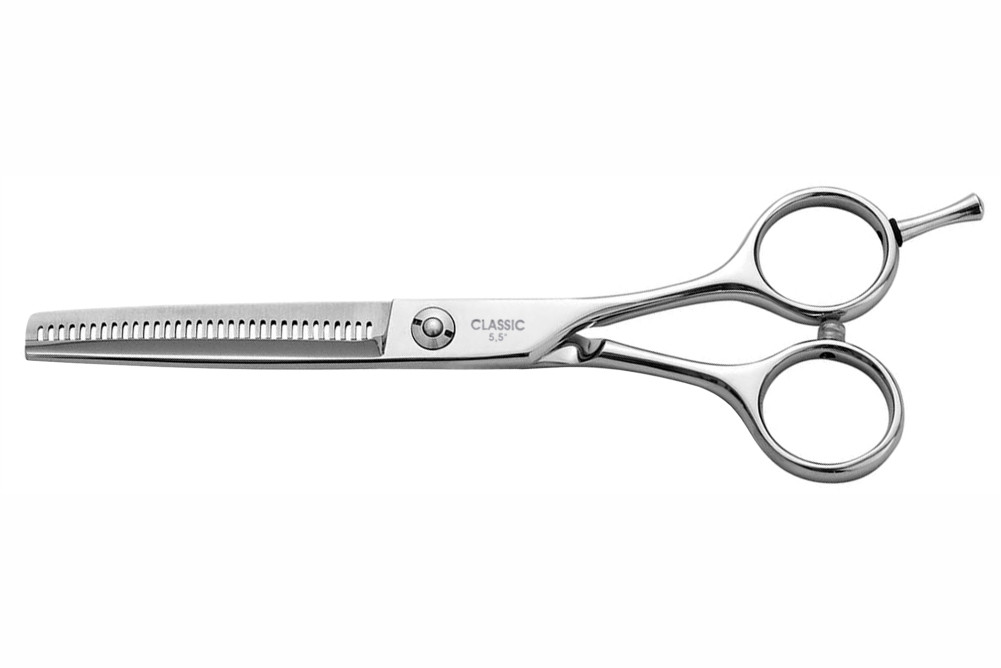 Tesoura profissional de metal prateado com dentes serrilhados