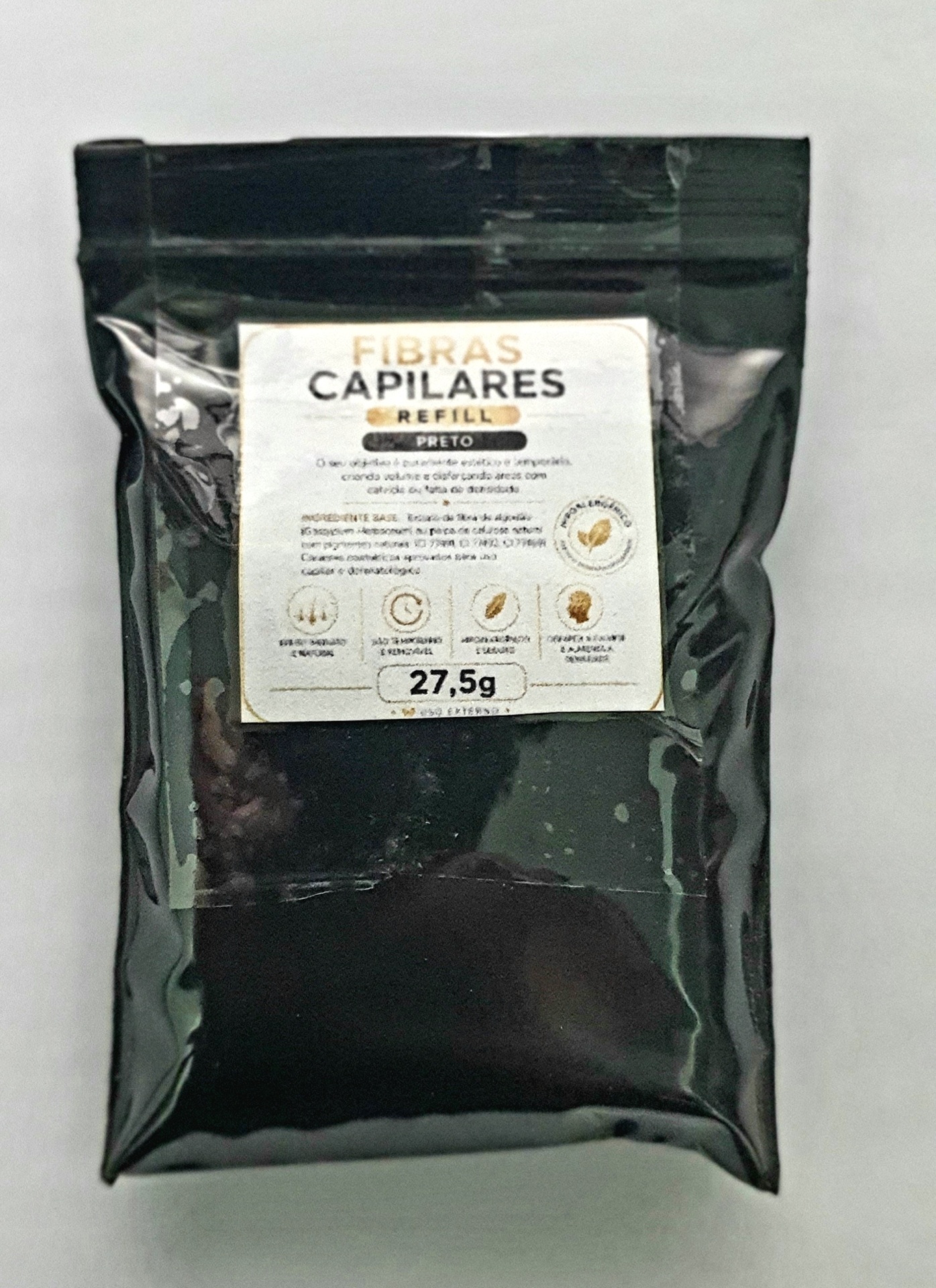 Embalagem preta plástica com rótulo branco de fibras capilares refill preto