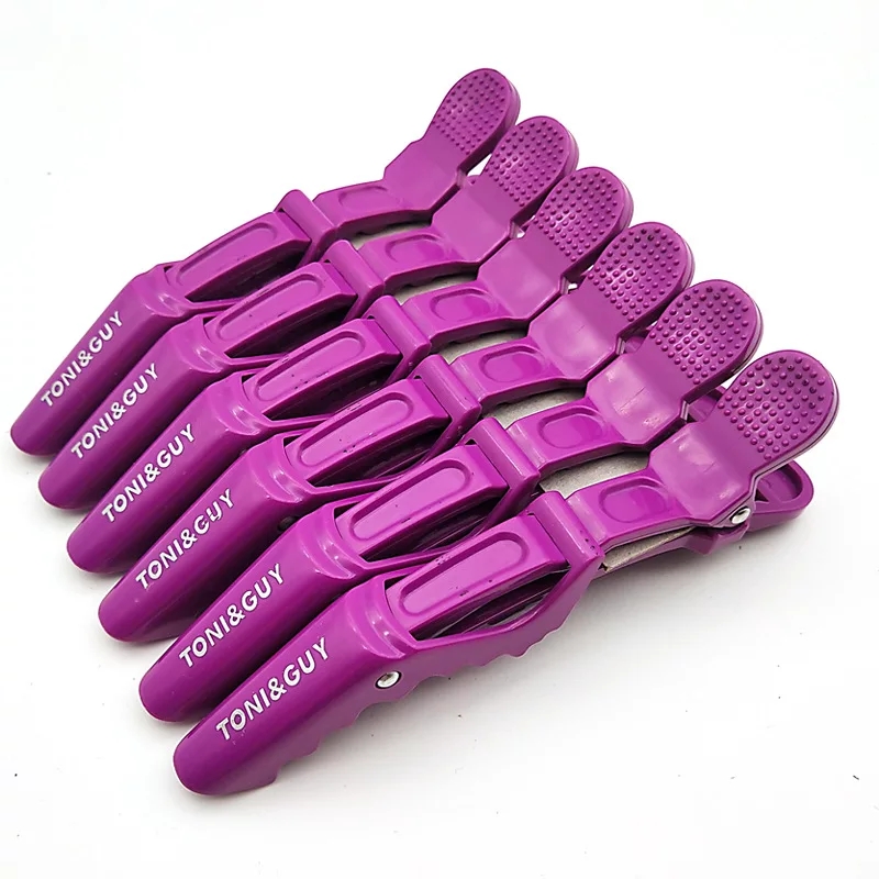 Prendedores de cabelo roxos com a marca TONI&GUY