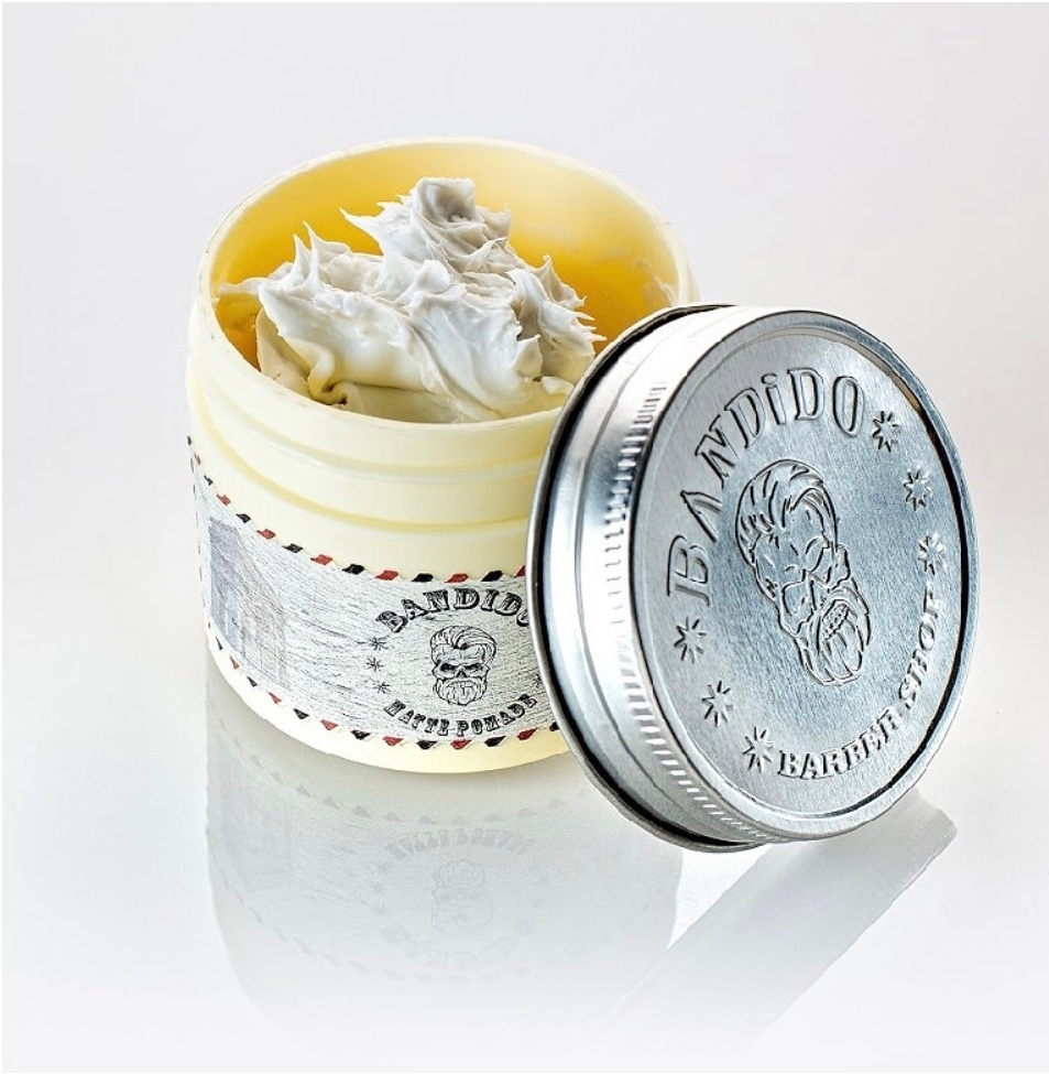 Frasco aberto de creme para barba da marca BANDIDO com tampa de metal prateada ao lado
