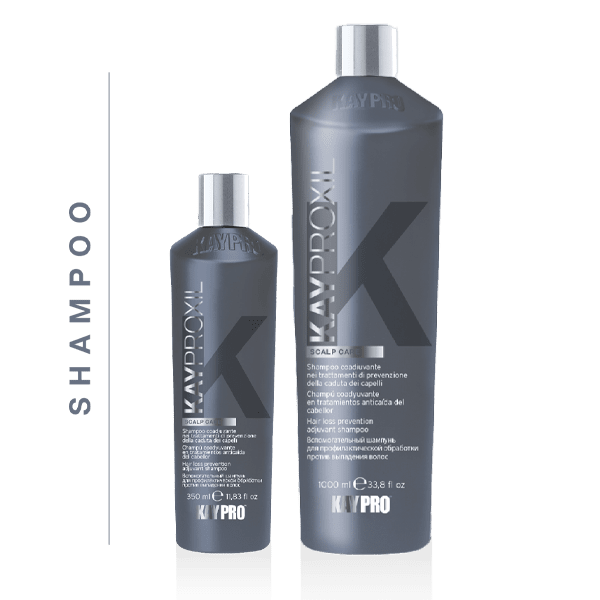 Dois frascos cinza de champô KAYPRO XL SCALP CARE com tampas prateadas e texto branco e cinza, tamanhos 250 ml e 1000 ml