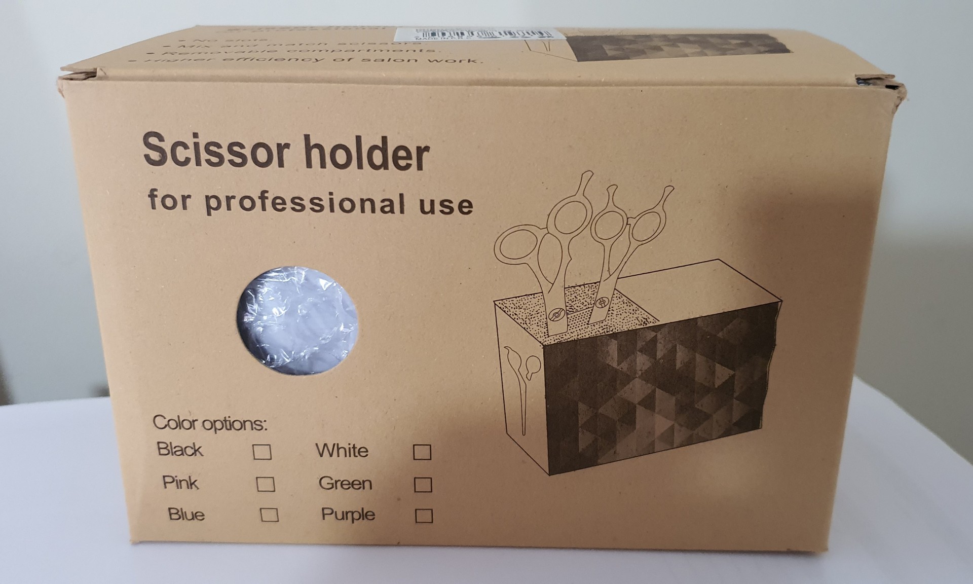 Caixa de suporte para tesouras para uso profissional em cartão castanho com texto e desenho do produto.