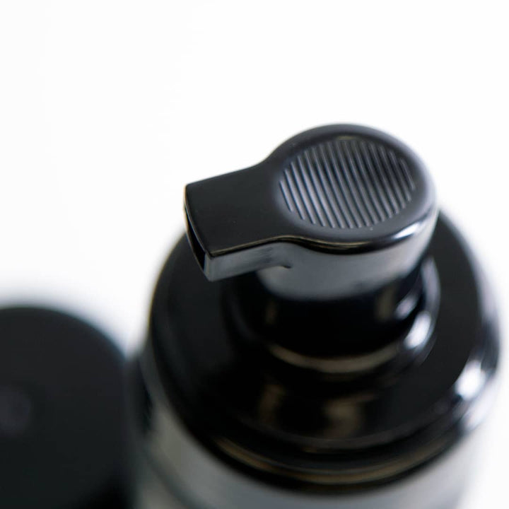 Bomba de doseador preta em plástico com ranhuras no bico