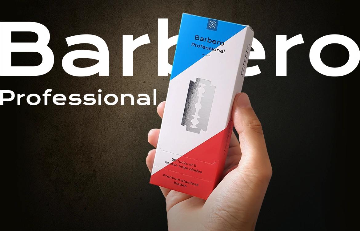 Caixa branca de lâminas de barbear Barbero Professional com detalhes azul e vermelho segurada à mão