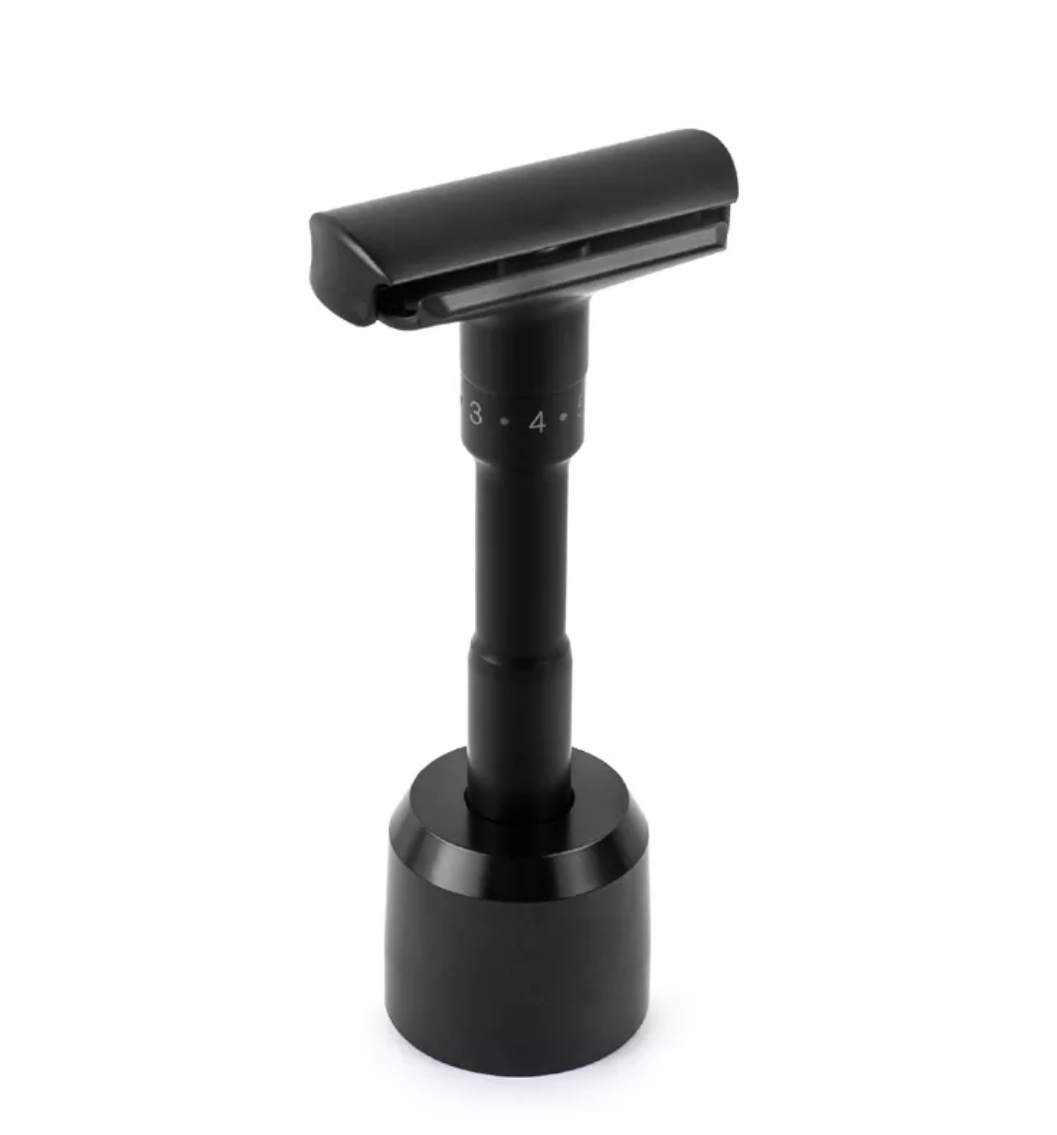 Aparelho de barbear preto com suporte