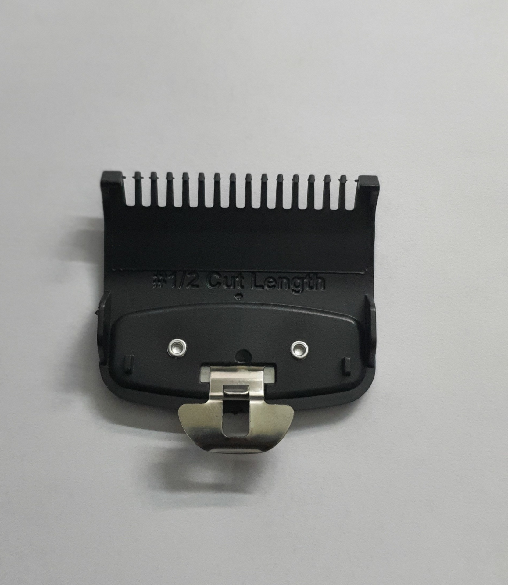 Pente de aparador de cabelo preto com texto '#1/2 CUT Length'