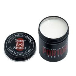 Embalagem preta aberta com creme branco e texto 'PORTOBELLO' e 'MATTE CLAY HIGH ELEGANCE POMADE'