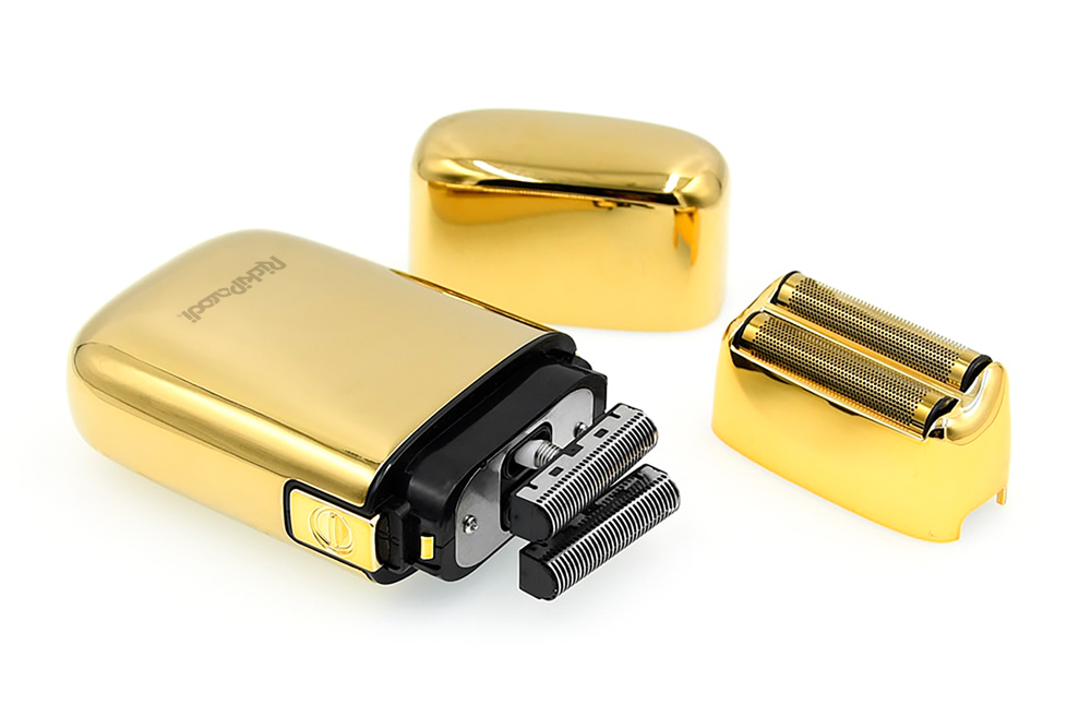 Aparelho de barbear elétrico dourado com peças destacadas