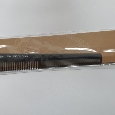 Pente preto em embalagem castanha com ilustração de navio