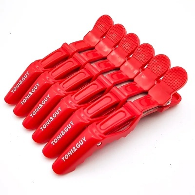 Seis molas de cabelo vermelhas TONI&GUY alinhadas