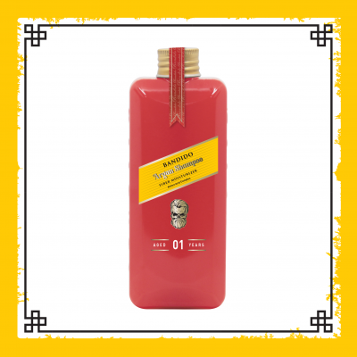 Frasco vermelho de champô Bandidó Argan Shampoo com etiqueta amarela e tampa dourada