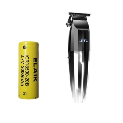 Cortador de cabelo preto JRL ao lado de uma bateria amarela com texto preto