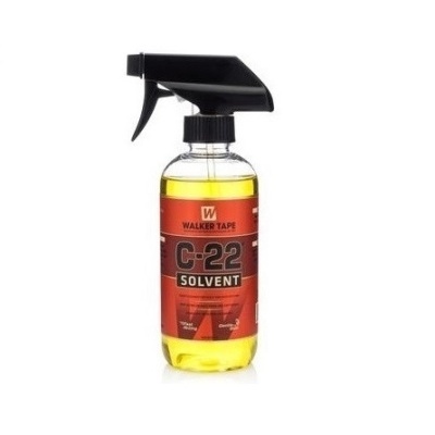 Frasco spray com líquido amarelo e etiqueta vermelha e preta