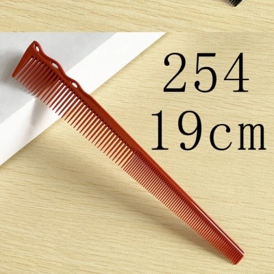 Pente de plástico laranja de 19 cm sobre mesa de madeira clara com texto ao lado