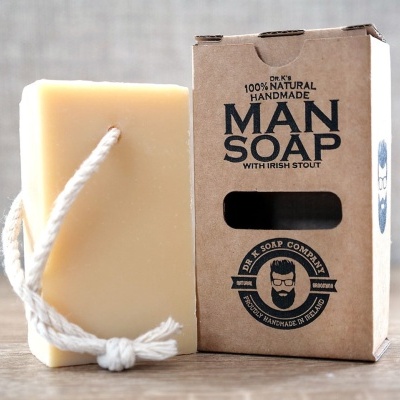 Sabonete amarelo com cordão e embalagem de papel kraft com texto preto