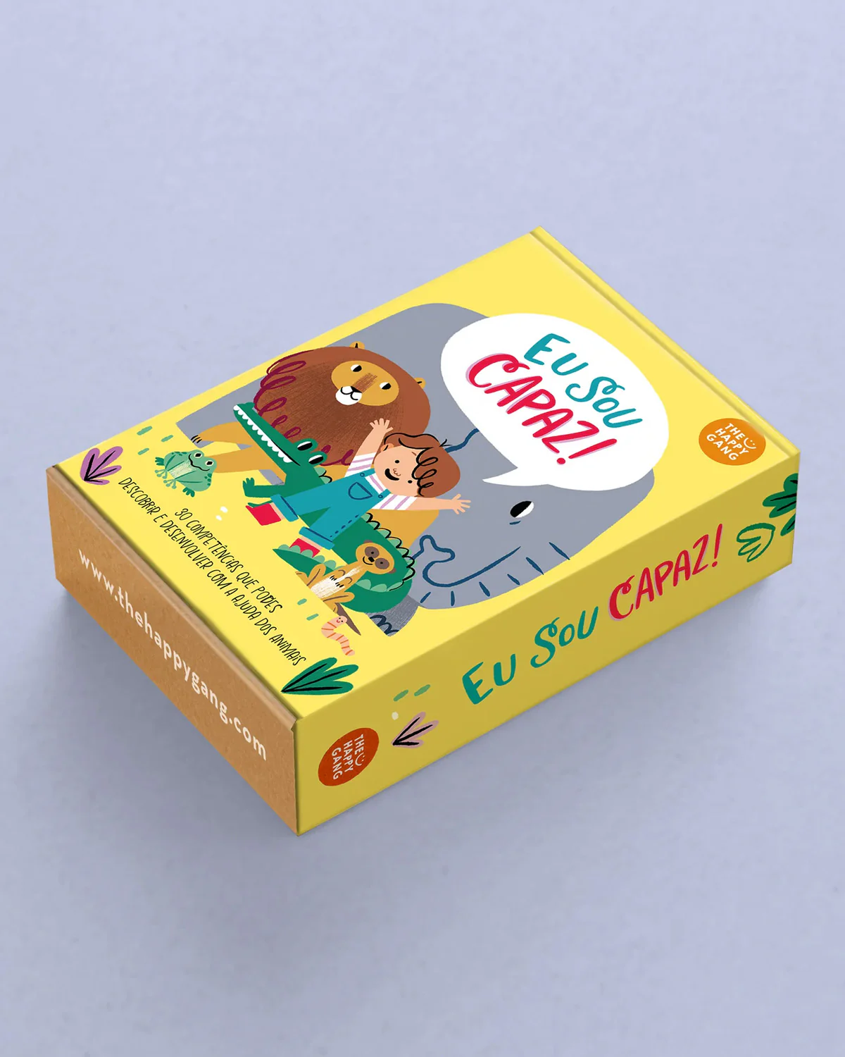 Caixa amarela com ilustração de leão, criança e elefante e texto Eu Sou CAPAZ!