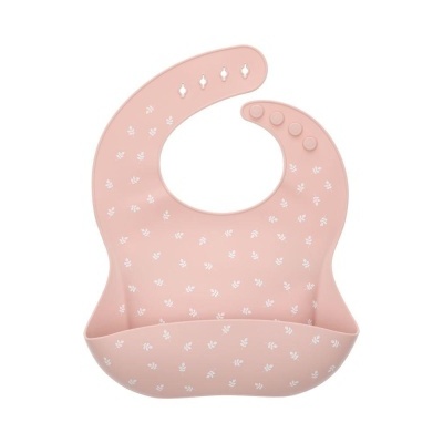 Babete de silicone rosa claro com padrões brancos e fecho de botões.