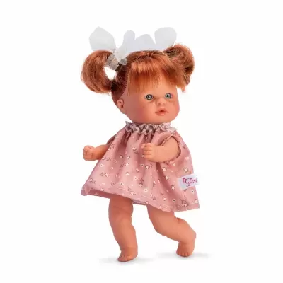 Boneca de plástico com vestido rosa e laços brancos no cabelo