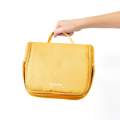 Necessaire amarela com estrelas brancas e o texto 'tutete'