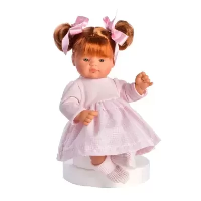 Boneca ruiva com vestido rosa clara e fitas rosas no cabelo, sentada
