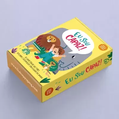 Caixa amarela com ilustração de leão, criança e elefante e texto Eu Sou CAPAZ!