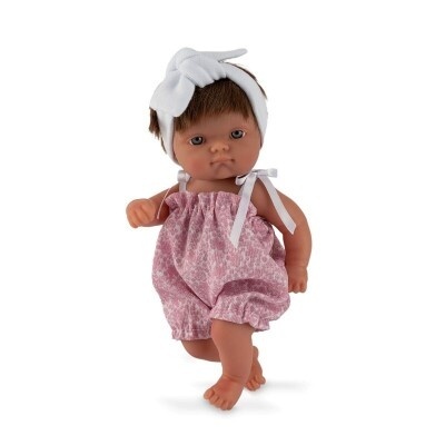 Boneca castanha com macacão rosa e faixa branca na cabeça