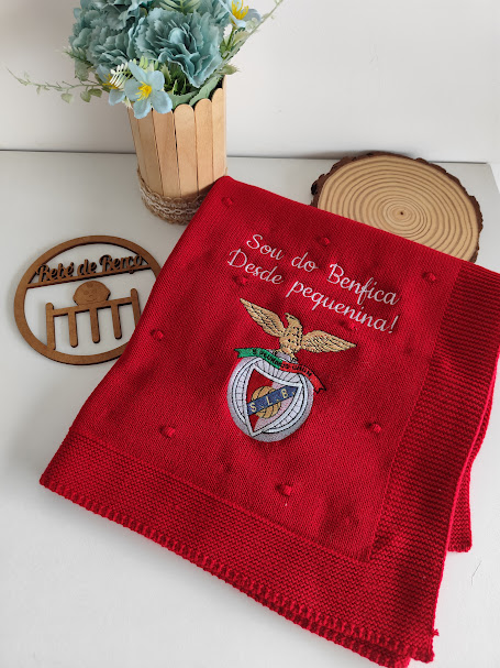 Manta vermelha do Benfica com bordado e vaso de flores azul