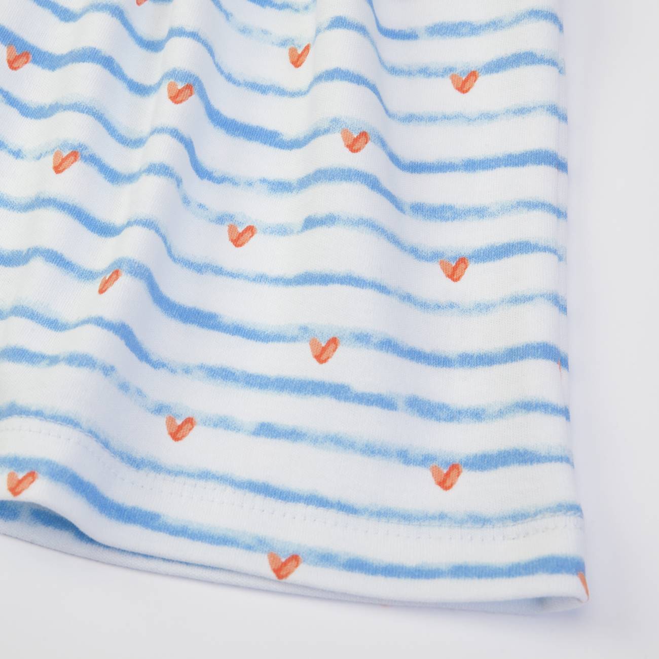 Tecido branco com riscas azuis e corações laranja
