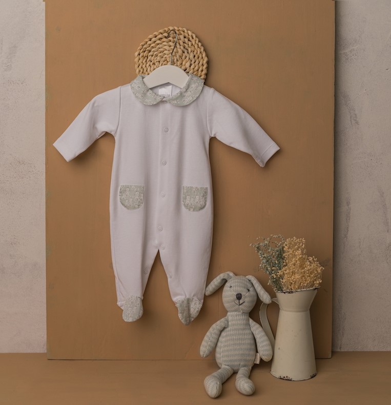 Macacão de bebé branco com detalhes cinzentos, boneco de coelho e jarro com flores secas