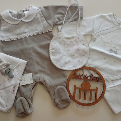 Conjunto de roupa de bebé com macacão cinza, body branco, babete branco, chucha com fita e lenço brancos