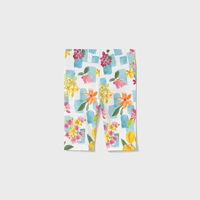 Calças de criança com padrão de flores coloridas e quadrados azuis