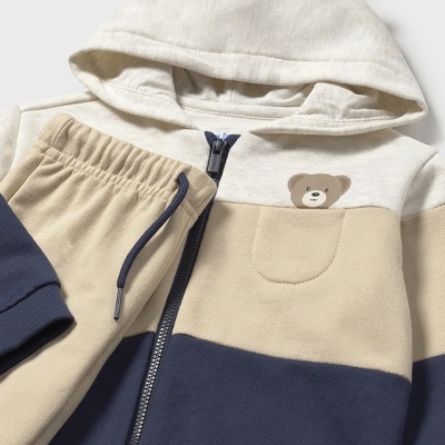 Conjunto de roupa infantil com capuz tipo urso nas cores bege, azul-marinho e branco