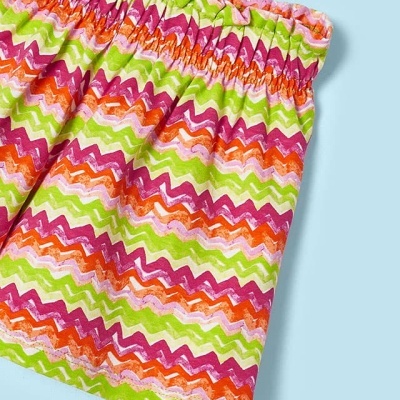 Pano colorido com padrão ziguezague rosa, verde, laranja e branco