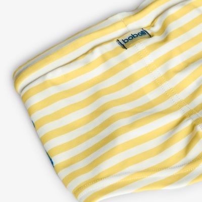 Calças às riscas amarelas e brancas com etiqueta babalú