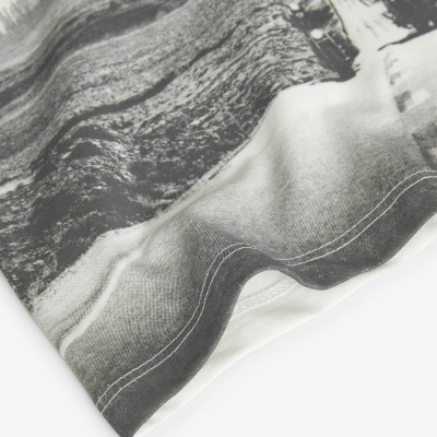 Detalhe de tecido com estampa a preto e branco e costuras brancas