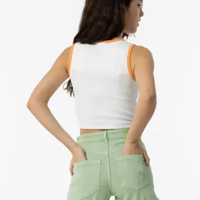 mulher de costas com top branco e calções verdes