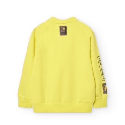 Camisola amarela para criança vista de trás com etiquetas e estampas castanhas