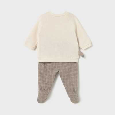Conjunto de roupa de bebé com camisola creme e calças castanhas quadriculadas.
