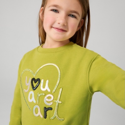 Camisola verde-lima com texto bordado em criança