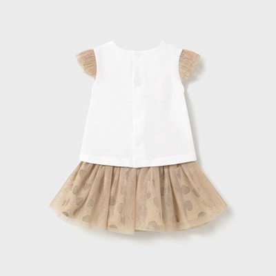 Vestido de criança com corpo branco e saia bege com padrão de corações