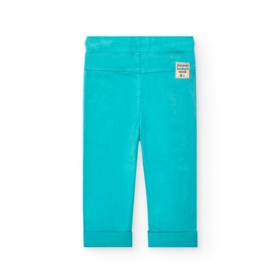 Calças de criança azul-turquesa com etiqueta