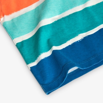 Detalhe da parte inferior de uma t-shirt às riscas em vários tons coloridos